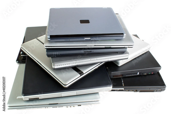Obraz Stack of used laptop computers, isolated on white