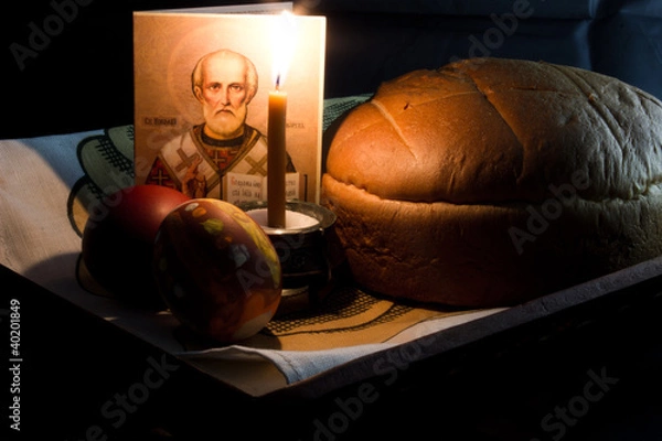 Obraz Easter eggs, a burning candle on a black background