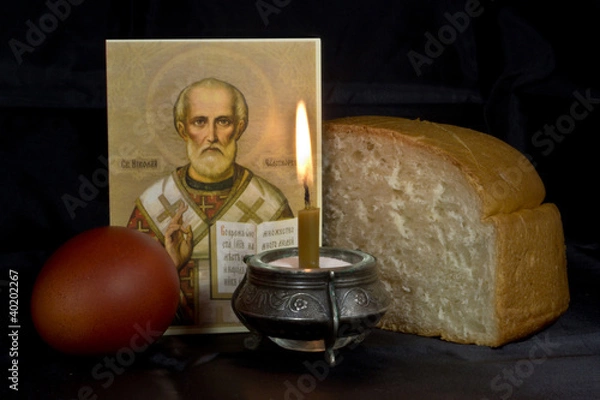 Obraz Easter eggs, a burning candle on a black background