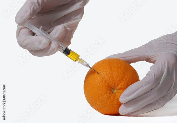 Obraz Orange with hypodermic needle