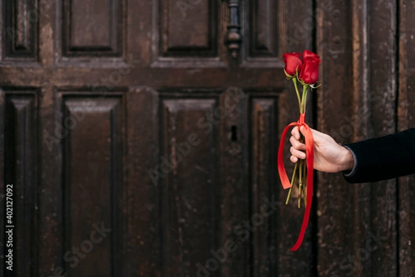 Obraz hand giving red roses bouquet to his couple with copy space