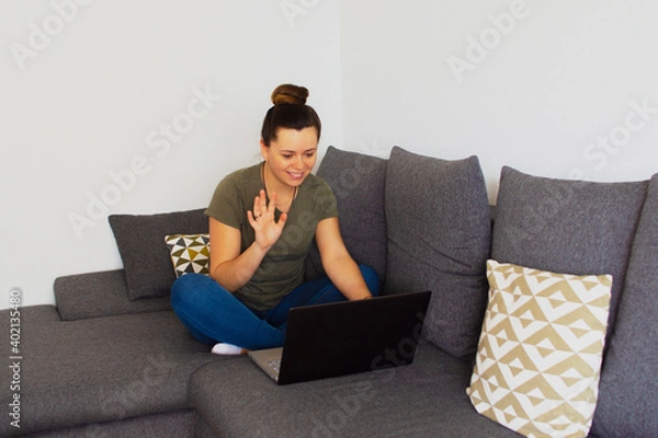 Fototapeta Girl at home working on the computer