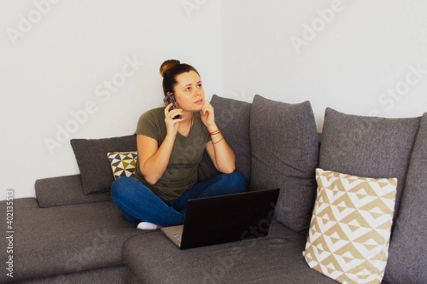 Fototapeta Girl at home working on the computer