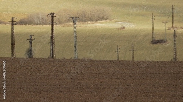 Fototapeta Electric power lines in field