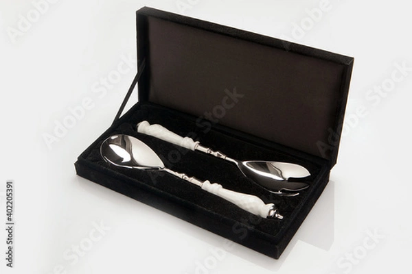 Obraz Black luxury velvet box, case including two silver tea spoons with white handles. Business present