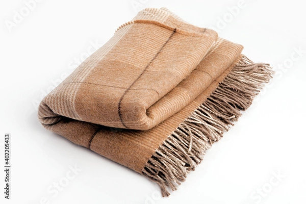 Fototapeta Warm brown alpaca wool or cashmere blanket isolated on white background. Beige, brown squared wool fabric for house design.