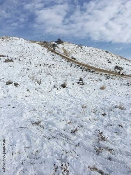 Fototapeta snow covered foothill