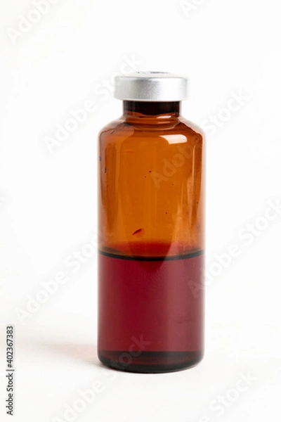 Fototapeta Macro Image Of Amber Vaccine Vial In White Background