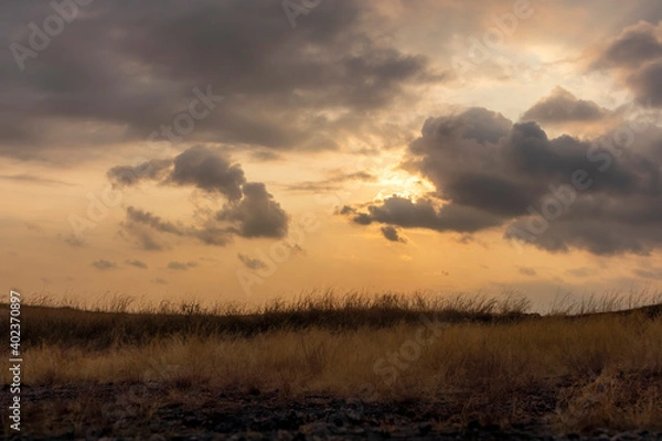 Fototapeta clouds with landscape during sunset