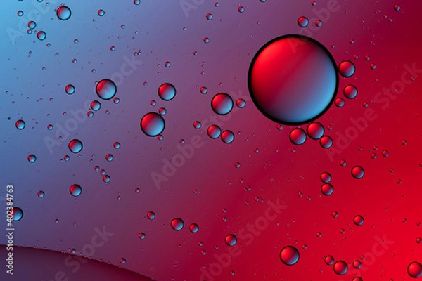 Fototapeta Blue and red bubbles. Abstract background. Bubble oil on water. Macro-photography.
