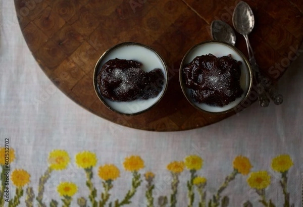 Fototapeta Traditional Finnish Easter dessert called Mämmi or Memma made of rye, served with cream and sugar. 