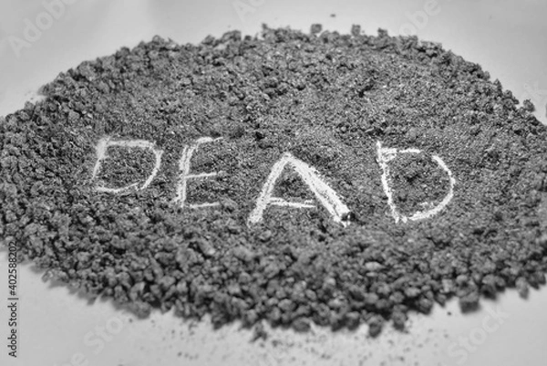 Obraz On a white background, close-up lies a mountain of ash, the word death is written in English