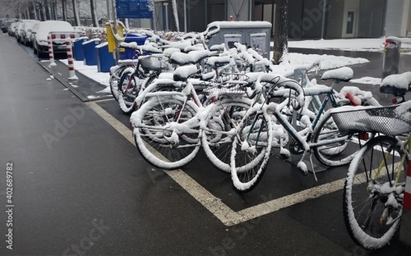 Fototapeta bicycles covered with snow on the street