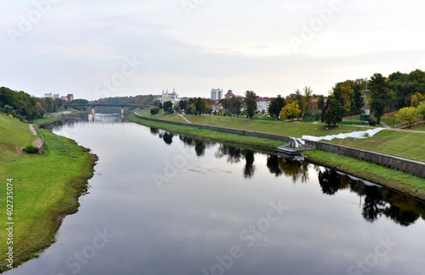 Fototapeta View of the Western Dvina (Zapadnaya Dvina) river in the center of the city of Vitebsk in the Republic of Belarus. Autumn landscape in town