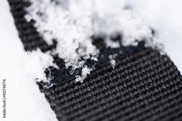 Fototapeta Black textile textures with icy snow flakes