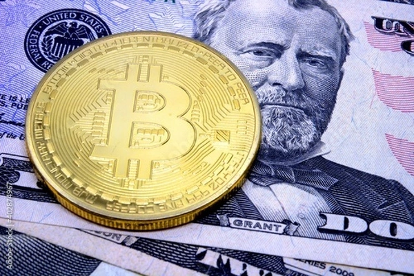 Fototapeta Bitcoin coin on the background of dollars. Virtual cryptocurrency concept. BTC vs USD.