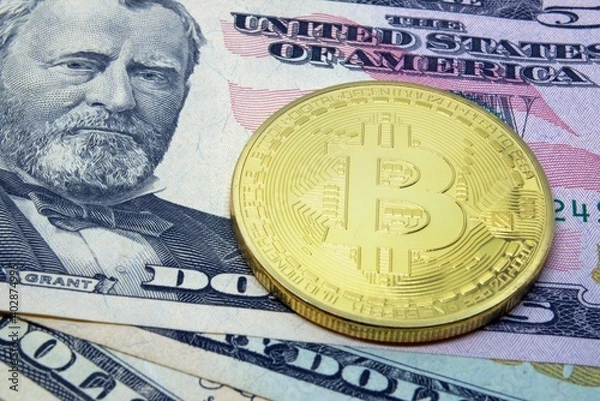Fototapeta Bitcoin coin on the background of dollars. Virtual cryptocurrency concept. BTC vs USD.