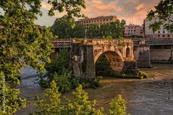 Fototapeta Amazing view of Tiber River and of the ancient Pons Aemilius in city of Rome. The remains of Pons Aemilius or Ponte Rotto, is the oldest Roman stone bridge in Rome, Italy