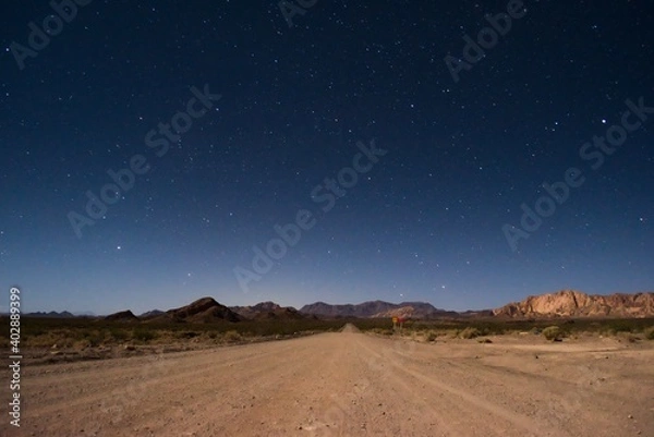 Obraz Starry night sky above a dirt road across the desert near Uspallata, Mendoza, Argentina.
