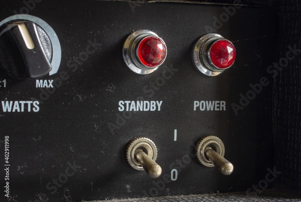 Fototapeta Buttons, knobs and lights of a guitar amplifier