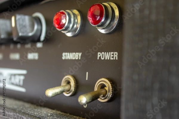 Fototapeta Buttons, knobs and lights of a guitar amplifier