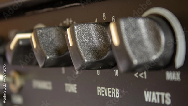Fototapeta Buttons, knobs and lights of a guitar amplifier