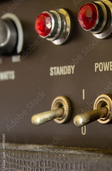 Fototapeta Buttons, knobs and lights of a guitar amplifier