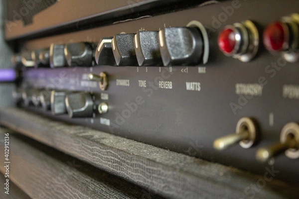 Fototapeta Buttons, knobs and lights of a guitar amplifier