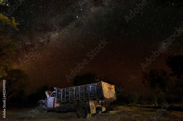 Obraz Old truck sits under night sky of stars.