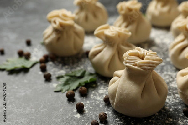 Fototapeta Khinkali, spices and flour on black smokey background