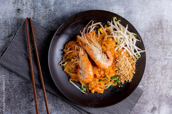 Fototapeta Udon Pad Thai with shrimp in a dark background, top view Asian style food Copy space