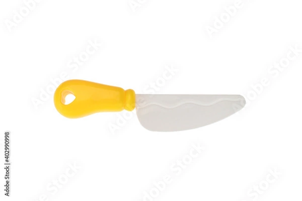 Fototapeta A plastic toy knife with a yellow handle. On a white background, isolated
