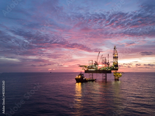 Fototapeta Aerial view offshore drilling rig (jack up rig) at the offshore location during sunset
