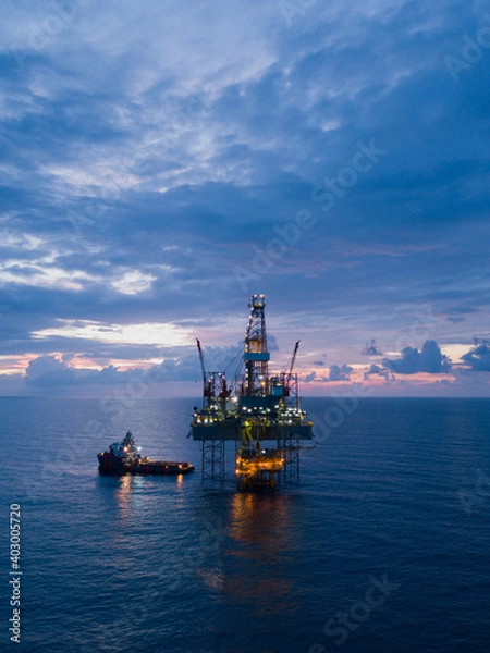Fototapeta Aerial view offshore drilling rig (jack up rig) at the offshore location during sunset