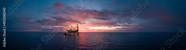 Fototapeta Aerial panorama view from a drone of an offshore jack up rig during sunset time at the offshore location
