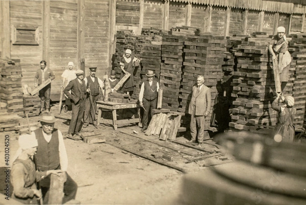 Fototapeta RUSSIA - CIRCA 1920s: Vintage archive photo of business owners managers and workers in rail sleepers factory. Sawmill
