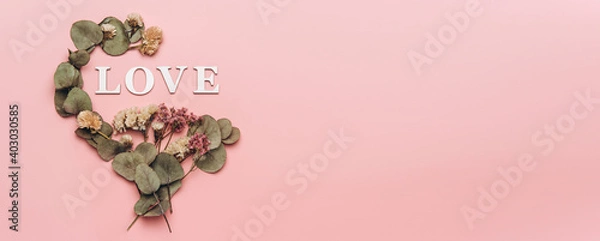 Fototapeta Creative flat lay of word love on soft color  background with natural plants