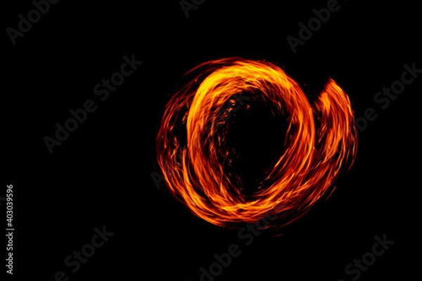 Fototapeta Circle of Fire flame with movment isolated on black isolated background - Beautiful yellow, orange and red and red blaze fire flame texture style.