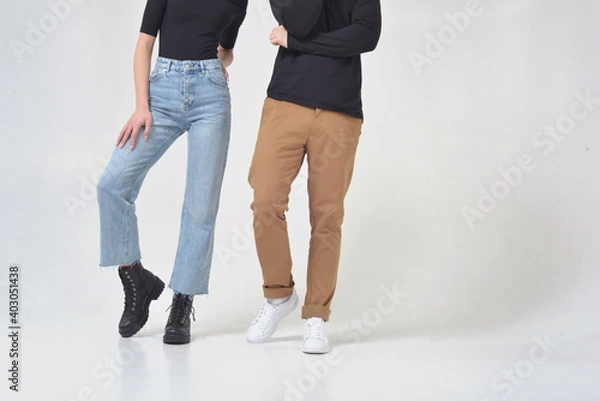 Obraz Young couple without faces posing in studio on white background in clothes