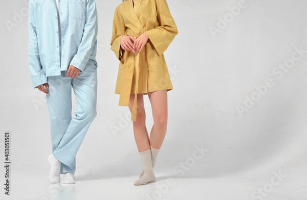 Obraz Young couple in the studio in night pajamas without a face on a white background