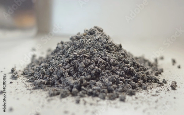 Obraz A mountain of ash on the table lies