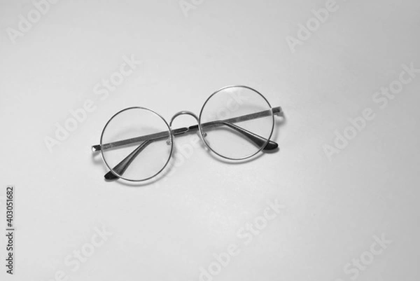 Obraz Glasses with transparent lenses lie on a white background