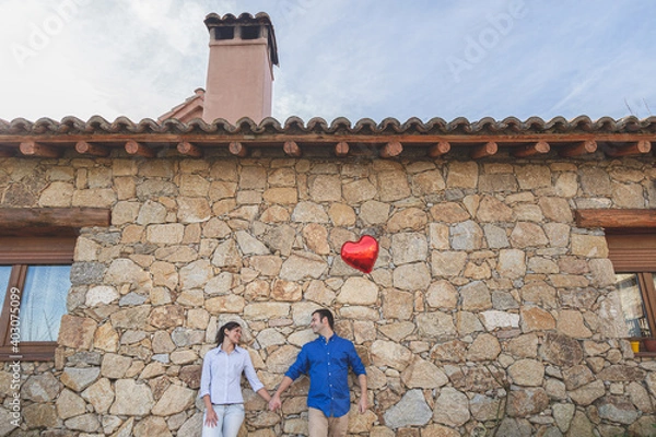 Fototapeta Young couple  Hugging, kissing and enjoying spending time together while celebrating Saint Valentine's Day in the countryside. Love san valentin and Relationship concept.