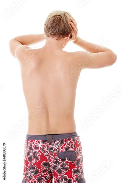 Obraz A young man grasping his head where the pain is