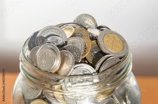 Obraz Close-up on polish coins in glass jar.