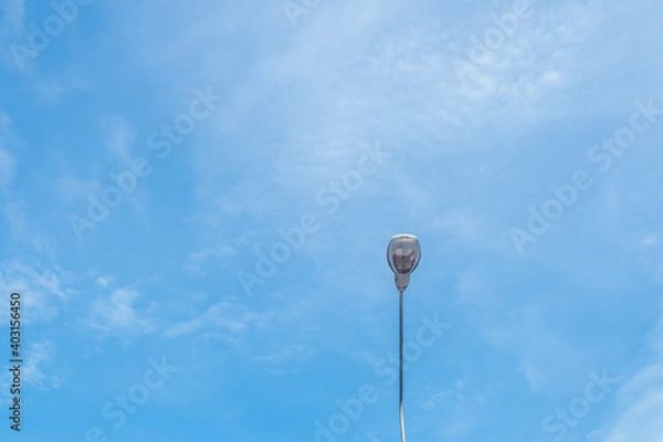 Fototapeta The street light pole stand against the bright blue sky background with copy space