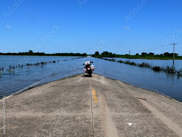 Obraz Motorcycle on flooded road