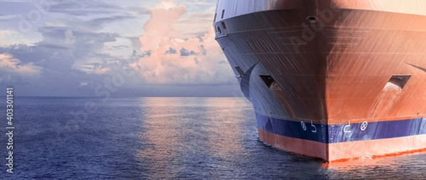 Obraz Close up of large merchant cargo ship in the middle of the ocean underway. Performing cargo export and import operations.