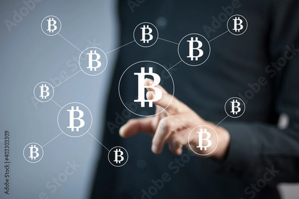 Fototapeta man touching bitcoin in screen