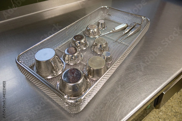 Fototapeta some various surgical instruments lie in sieves on a work surface